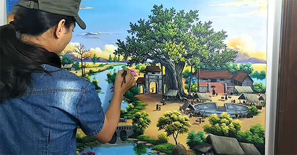 Họa sĩ chuyên nghiệp đang vẽ tranh tường phòng khách tại Hưng Yên với chi phí thấp